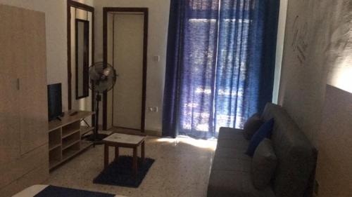 a living room with a couch and a window at Le Malte House St. Julians in St Julian's