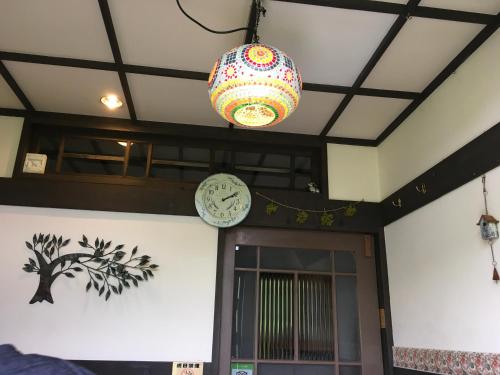 a clock and a chandelier hanging from a building at Pension Kinouta in Biei