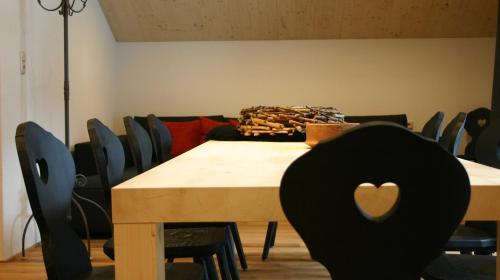 a table with chairs and a wooden table with a heart on it at MO Chalet in Gaschurn