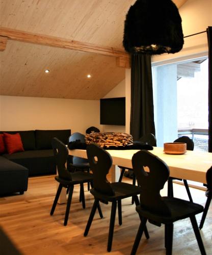 a dining room with a table and chairs at MO Chalet in Gaschurn