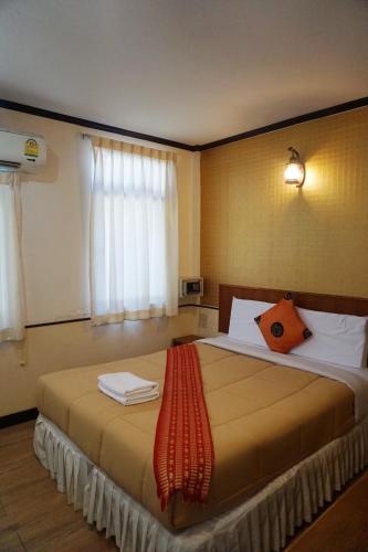 a bedroom with a large bed with towels on it at Honey House1 hotel in Bangkok