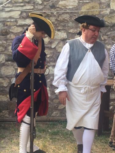 a man standing next to a woman dressed in uniform at Medieval Village B&B in Ne