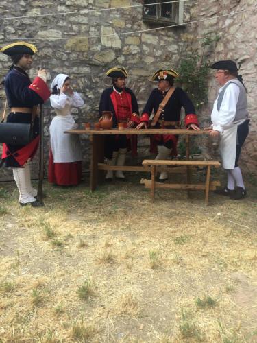 a group of people in medieval clothing standing around a table at Medieval Village B&B in Ne
