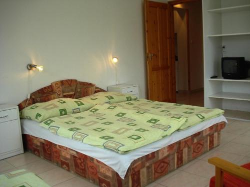 A bed or beds in a room at Klassz Apartmanház