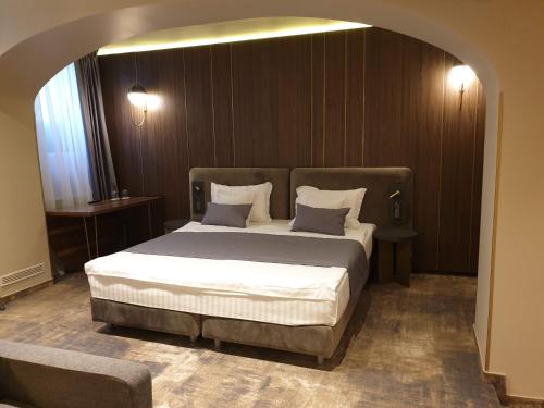 a bedroom with a large bed in a room at Vila Siago in Cluj-Napoca