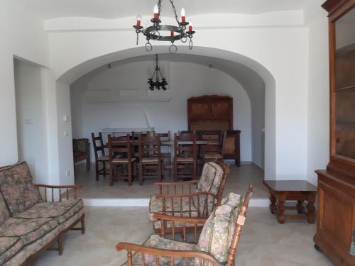 a living room with chairs and a dining room at Casa Iacobucci in Fagnano Alto