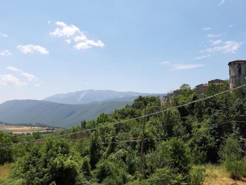 a view of a mountain with a tower and trees at Casa Iacobucci in Fagnano Alto