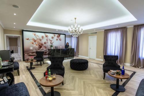 a living room with chairs and a large screen at The Boutique Hotel in Rome