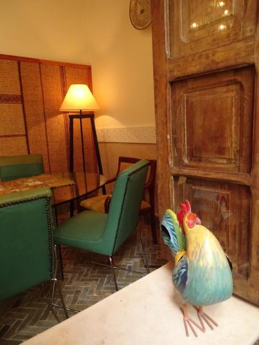 a bird sitting on a table in a room at Riad Le Coq Berbère in Marrakech