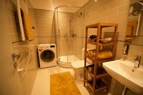a bathroom with a shower toilet and a sink at Riga A new designed cosy family apartment in Riga
