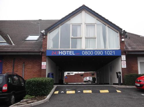 a parking lot in front of a building at 247Hotel in Oldham