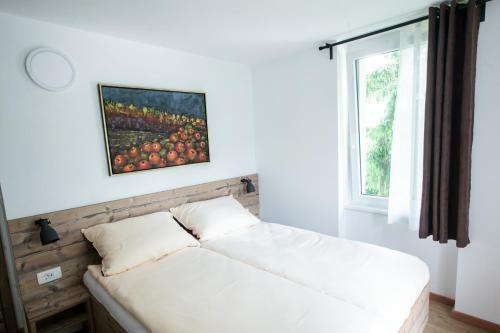 a bed in a room with a window at Hiša Poljana Rooms in Prevalje
