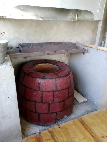 a brick oven in a room with a brick floor at Cozy House in Bina, Bolluq in Baku