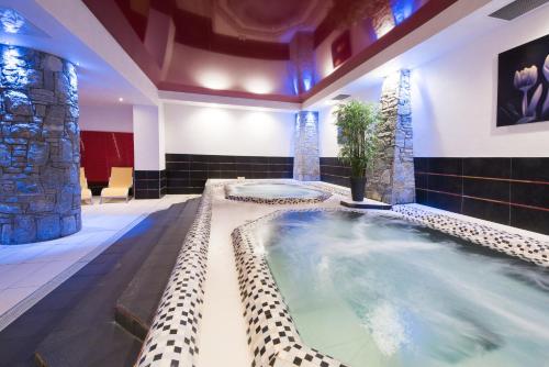 un grand bain à remous intérieur dans une maison dans l'établissement CGH Résidences & Spas Le Centaure, à Flaine
