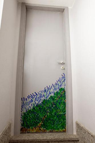 a door with a painting of blue flowers on it at Il Giramondo in Busca