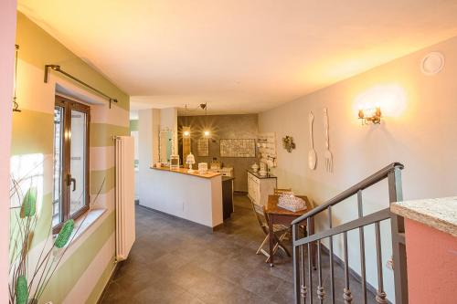 a kitchen with a staircase leading to a living room at Il Giramondo in Busca