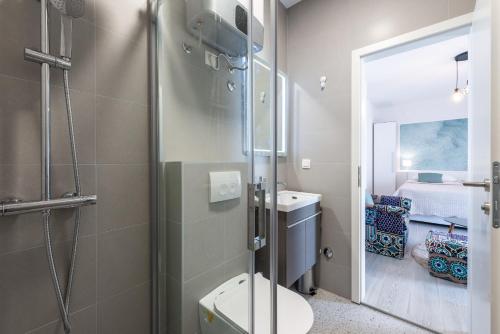 a bathroom with a shower and a toilet and a sink at Villa Mimoza in Cavtat