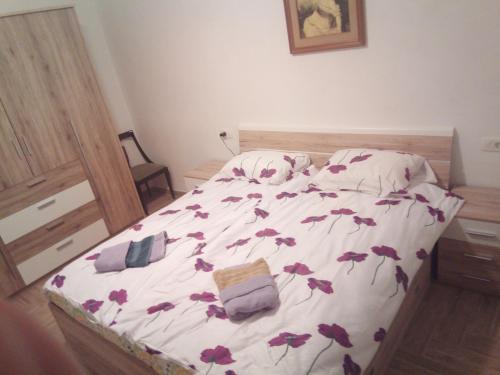 a bed with flowers on it in a bedroom at APARTMAJI MATAŽIN in Črni Kal