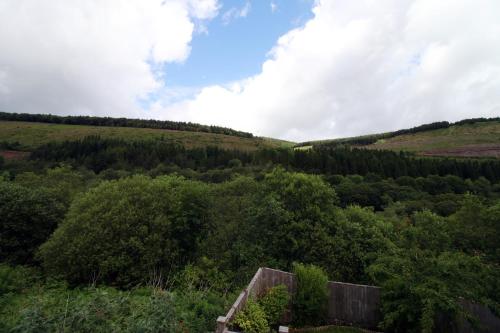 a view of a hill with trees in a field at The Nook In The Afan Forest Bike Park by StayStaycations in Port Talbot