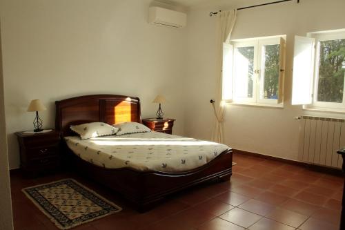 a bedroom with a bed and two windows at Azul Coruche in Coruche