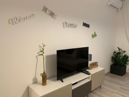 a living room with a flat screen tv on a white wall at ORIGO in Győr