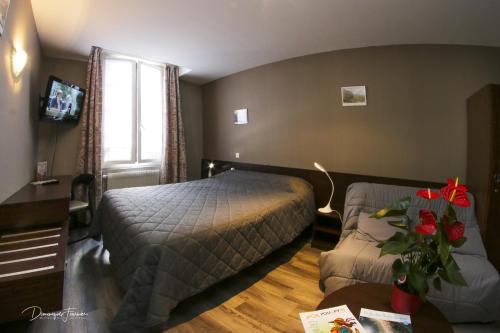 a hotel room with a bed and a couch at hotel des 2 nations in Luchon