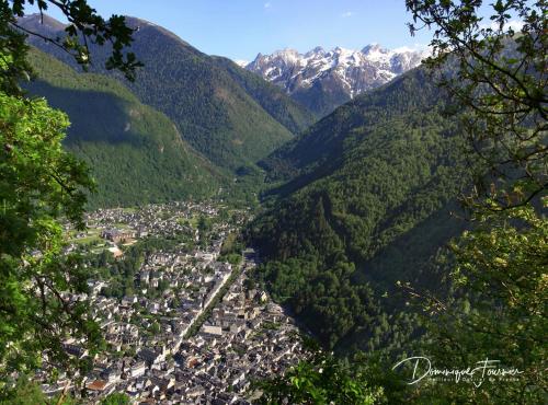 an aerial view of a town in a valley with mountains at hotel des 2 nations in Luchon