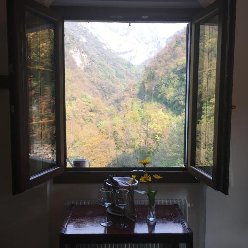 a window with a view of a mountain at Hotel Al Verde in Mandello del Lario