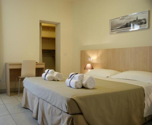 a hotel room with two beds with towels at Residence Belmare in Rimini