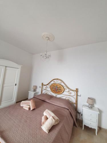 a bedroom with a bed with two towels on it at BnB Le Janas in Càbras