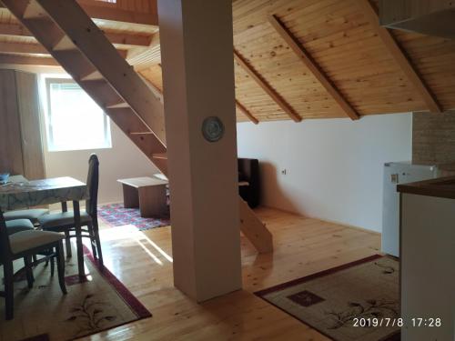 a kitchen and dining room with a wooden ceiling at Durmitor Apartments Holiday in Žabljak