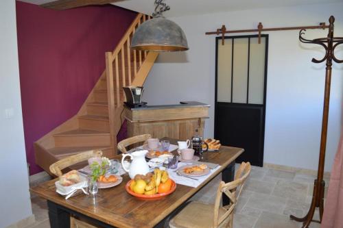 a table with food on it in a room at Le MAGNOLIA in La Croix-en-Touraine