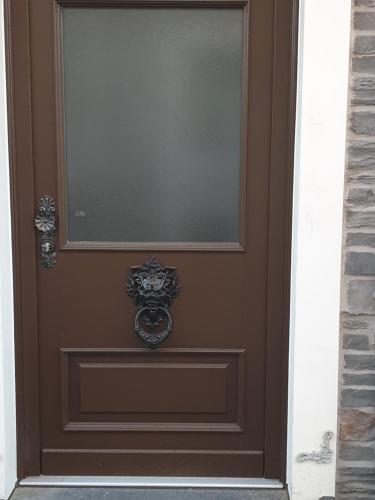 a brown door with a window on it at Villa Ferialis in Xanten