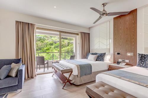 a hotel room with two beds and a window at Royalton Antigua, An Autograph Collection All-Inclusive Resort in Five Islands Village