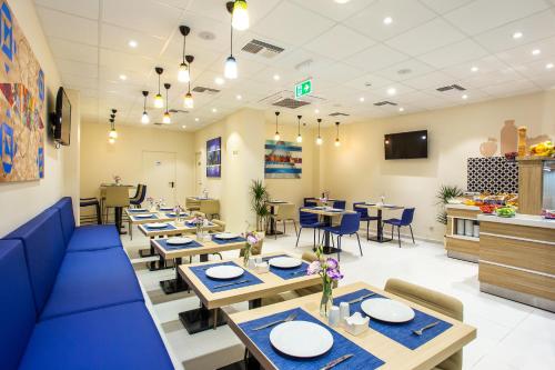 a dining room with blue tables and chairs at Best Western Terminus Hotel in Sofia