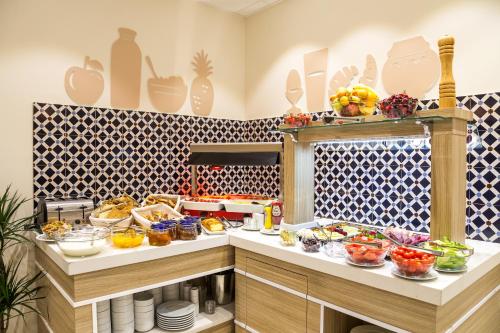 a kitchen with a bunch of food on a counter at Best Western Terminus Hotel in Sofia