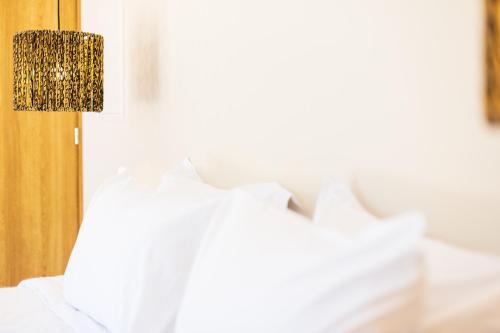 a close up of a bed with a lamp at 180 South Seaside Hotel in Thermisia