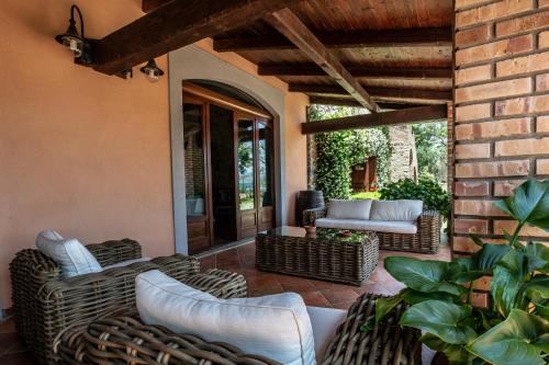 a patio with wicker furniture and a brick wall at Lolivia Masseria & Ristoro in Senise