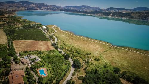 an aerial view of a lake with a house at Lolivia Masseria & Ristoro in Senise