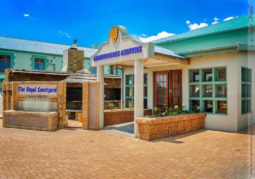 a building with a sign that reads hurricane garage at The Royal Courtyard in Matatiele