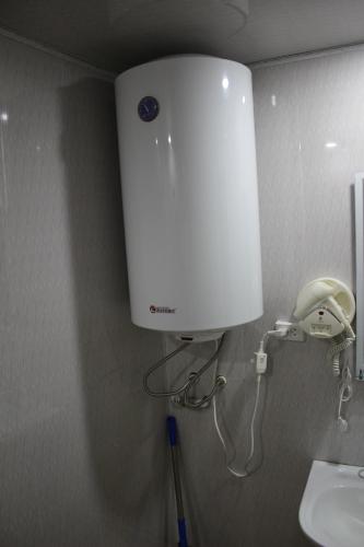 a blow dryer in a bathroom with a sink at Ecohouse Svaneti in Mestia