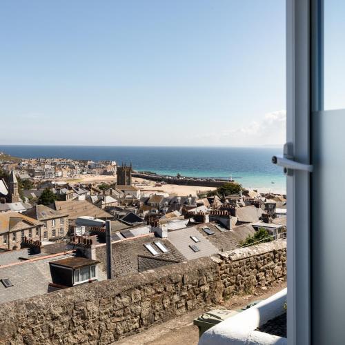 a view of a coastal town from a window at Ocean House in St Ives