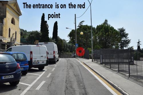 an image of a street with vehicles parked on the road at Gabbiano in Malcesine