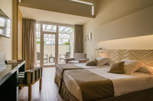 Кровать или кровати в номере Hotel Alga