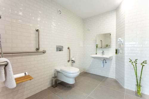 Baño blanco con aseo y lavamanos en Best Western Terminus Hotel, en Sofía