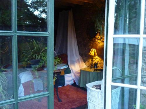 a room with a bed and a table with a lamp at Cullintra House in New Ross