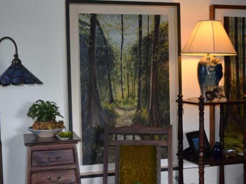 a room with a painting on the wall next to a lamp at Cullintra House in New Ross