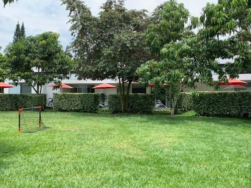 a yard with a swing set in the grass at La Masia Hotel Boutique in Anapoima