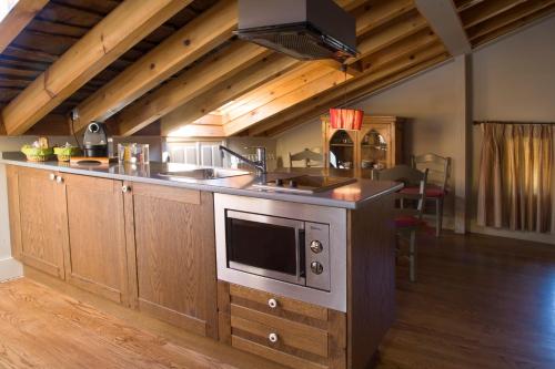 eine Küche mit einer Spüle und einer Mikrowelle in der Unterkunft CASA ALDABA in La Hiruela