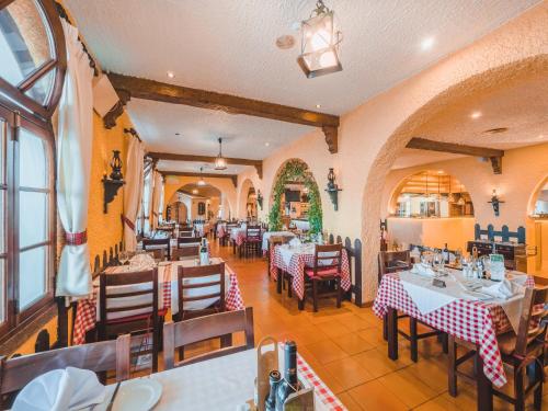 a restaurant with tables and chairs in a room at Ocean Gardens in Funchal